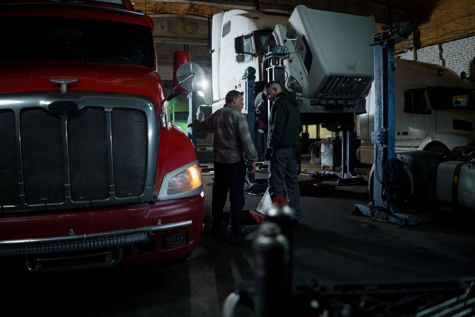 Mechanics servicing a prime mover in the workshop